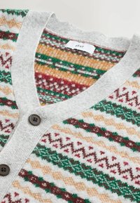 Gray cardigan featuring a V-neck, button closure, and patterned knit in red, green, beige, and brown. Soft, textured fabric.