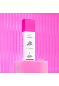 Drunk Elephant T.L.C. Framboos Glycolic Night Serum in a pink rectangular bottle with a matching cap, labeled with white text and a logo.