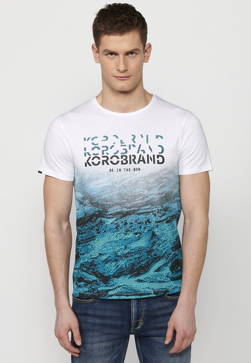 White short-sleeve T-shirt featuring a blue graphic design with wave patterns and bold black text. Cotton fabric with a round neck.
