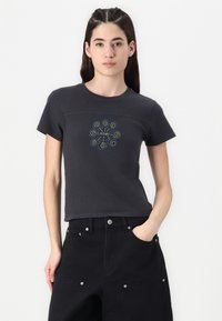 T-shirt nera a maniche corte con un motivo a spirale colorato sul davanti. Ha un colletto rotondo e un design aderente.
