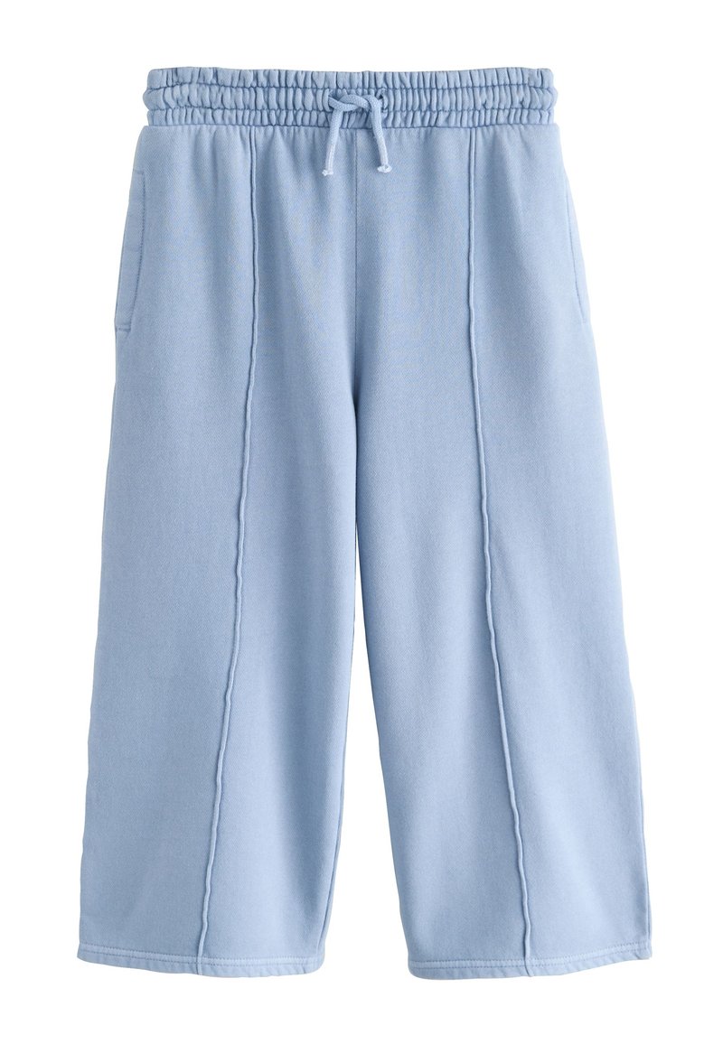 Pantalon large couleur bleu clair en tissu doux, avec une taille élastique et un cordon de serrage, deux poches latérales et des coutures.