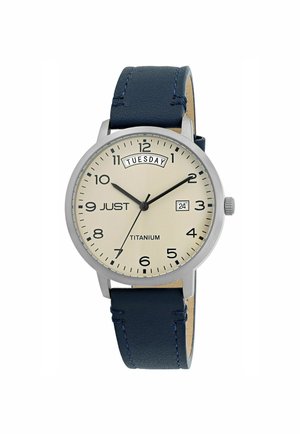 Titanium watch with a cream dial, black numerals, and date display. Features a blue leather strap with stitching accents.