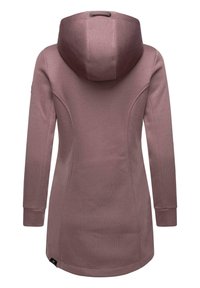 Long pink hoodie with a textured fabric, large hood, and side seams. Features ribbed cuffs and a slight curve at the hem.