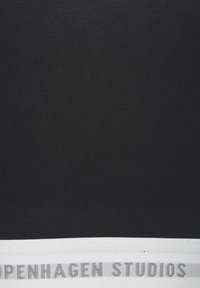 Black fabric with a smooth texture featuring a white band at the bottom, labeled "Copenhagen Studios" in gray text.