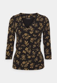 Black long-sleeve top with a V-neck and a wrap design, featuring a gold floral pattern throughout and soft, textured fabric.