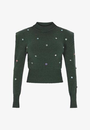 Roheline kudum, millel on kõrge kaelus, pärlitega kaunistatud mitmevärviliste gemmilaadsete detailidega, istuv siluett ning soonikkoes äär ja mansetid.