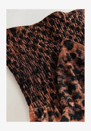 Brown and black leopard print fabric with gathered texture. Features a stretchable design for comfort and a smooth finished edge.