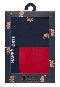 Two pairs of shorts in navy and red, featuring gingerbread and candy cane patterns. Packaged in a box with a hanger and "HAPPY SHORTS" label.