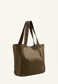 Brown fabric tote bag with two sturdy fabric straps, rectangular shape, smooth texture, and minimalistic design.