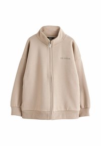 Giacca beige con zip e colletto alto, maniche ampie, polsini e orlo a coste; presenta la scritta "LTD. EDITION" ricamata sul davanti.