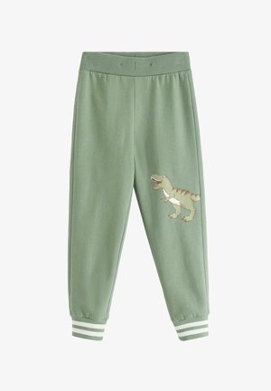 Groene kinderpants met geribde tailleband en boorden met witte strepen en een cartoon dinosaurus op de rechterdij.