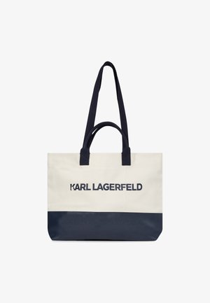 Canvas tote bag in crèmekleur met een marineblauwe bodem. Heeft dubbele marineblauwe handvatten en opvallende "KARL LAGERFELD" branding in marineblauw.
