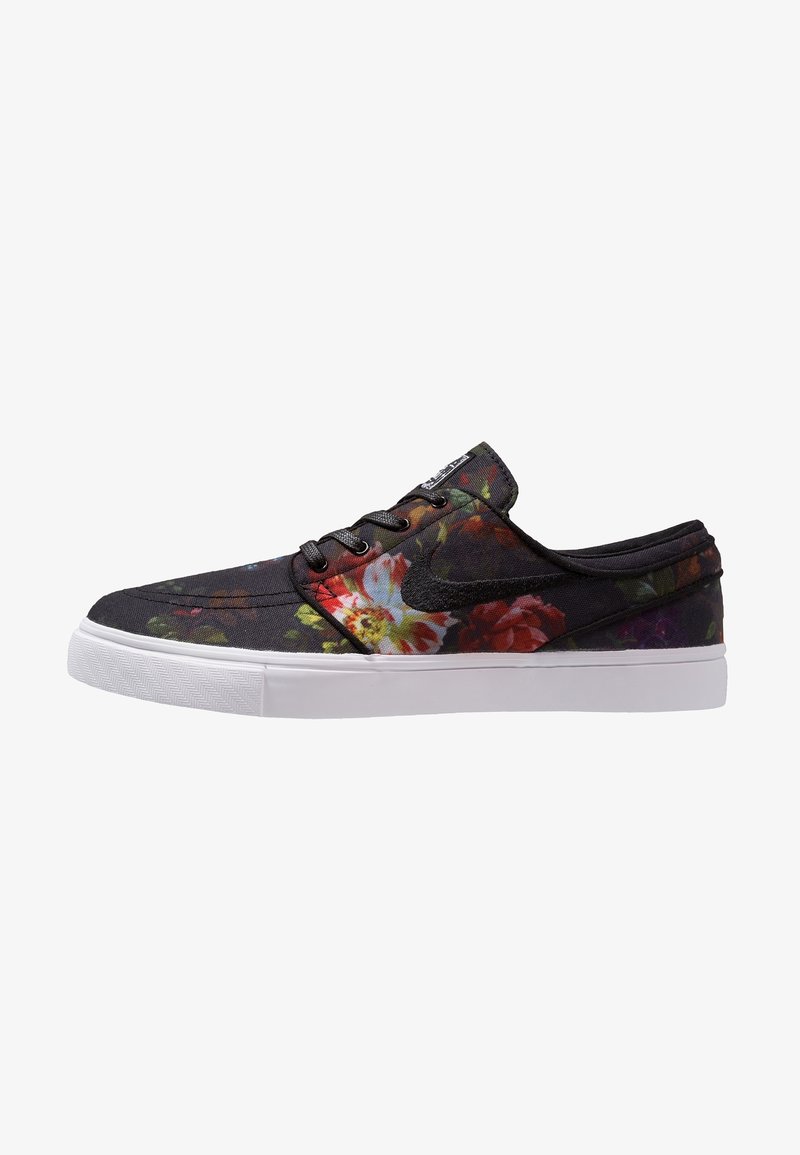 Baskets basses noires avec motif floral multicolore, lacets noirs et semelle en caoutchouc blanche, vues de côté.