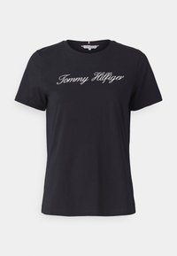T-shirt en coton noir avec des manches courtes et un col ras du cou. L'avant présente un logo "Tommy Hilfiger" brodé en blanc.