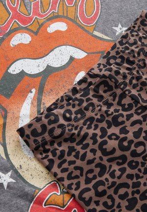 Gray t-shirt with Rolling Stones logo in orange and white; brown fabric with black leopard print pattern partially overlapping the shirt.