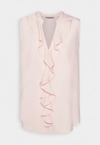 Blouse rose sans manches en tissu doux avec un décolleté en V et un détail à volants sur le devant. Texture lisse avec un ourlet arrondi.