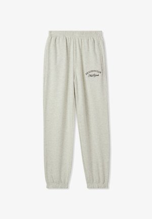 Pantaloni jogger grigi chiari realizzati in morbido misto cotone, con vita elasticizzata, polsini e testo stampato sulla tasca sinistra.