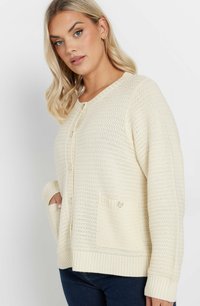 Cremefärgad stickad cardigan med ett texturerat mönster, rund halsringning, knappstängning och två framfickor med knapppynt.