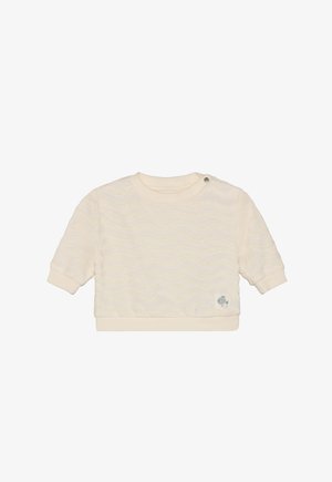 Sudadera de manga corta color crema con textura ondulada, puños y dobladillo acanalados, y un pequeño logo de pez azul en la parte inferior izquierda.