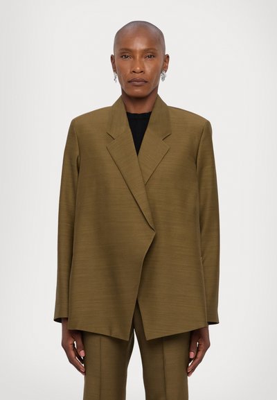 Olive green, oversized blazer with a notch lapel, textured fabric, and a straight cut. Includes long sleeves and slightly flared hem.