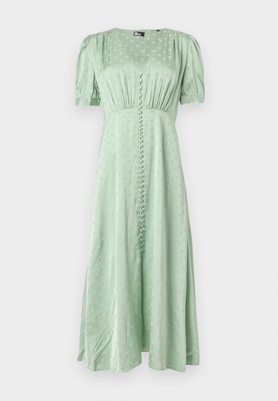 Φόρεμα μέσης σε ανοιχτό πράσινο χρώμα με φουσκωτά μανίκια, λαιμόκοψη V, κουμπιά καλυμμένα με ύφασμα μπροστά και διακριτικό σχέδιο καρδιάς.