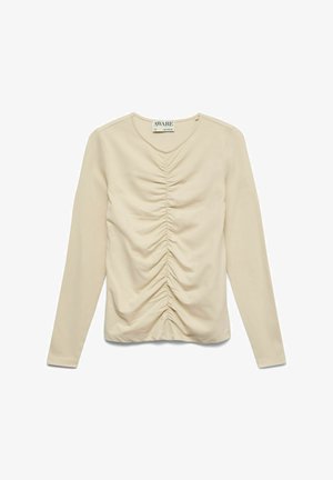 Bordinė ilgomis rankovėmis su raukiniais per vidurį priekyje ir apvalia kaklo linija.