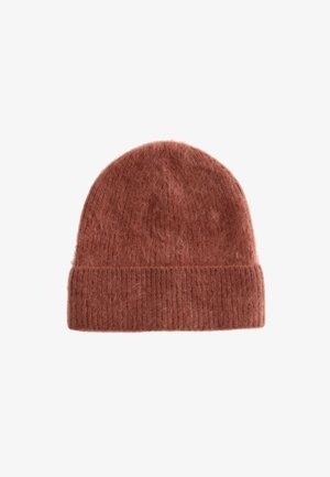 Rust-colored knitted beanie made of soft, fuzzy material with a ribbed cuff and rounded top, featuring a textured finish.