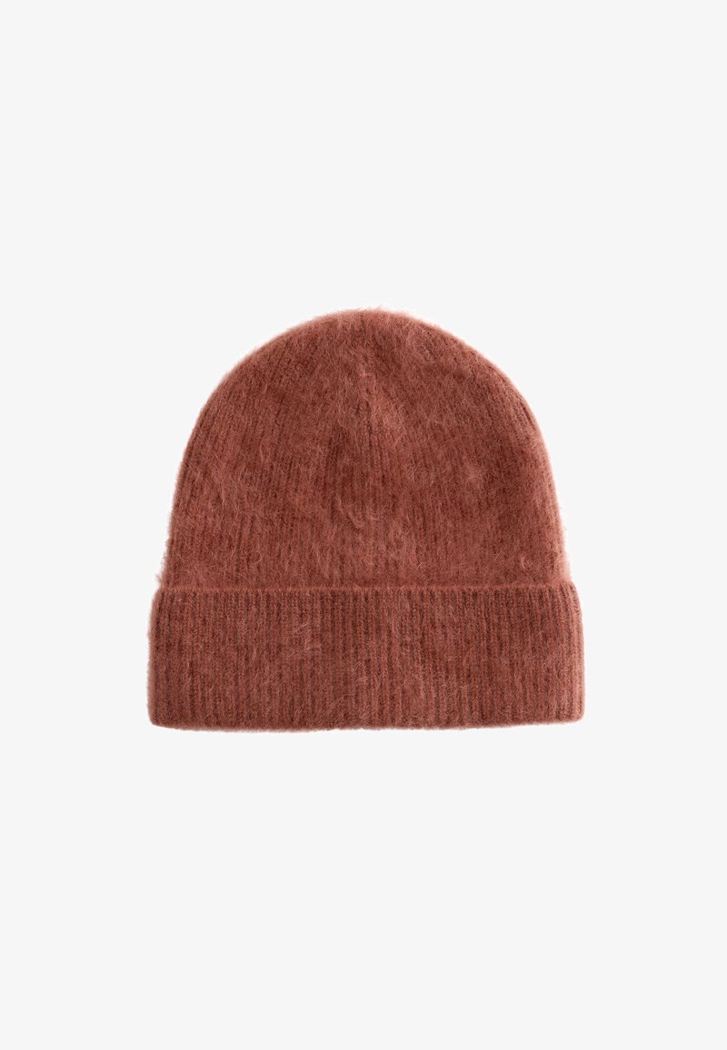 Rust-colored knitted beanie made of soft, fuzzy material with a ribbed cuff and rounded top, featuring a textured finish.