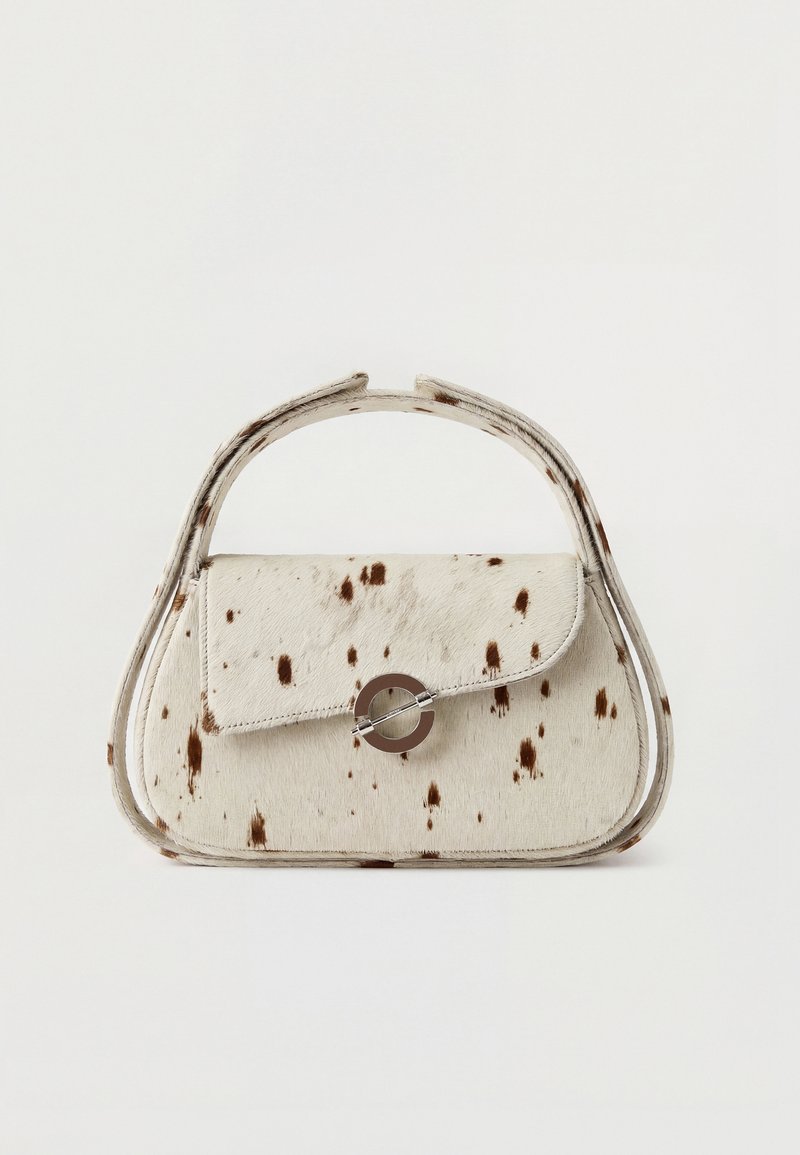 Μικρή μπεζ τσάντα χειρός με σκούρες καφέ κηλίδες, στρογγυλεμένες λαβές και κυκλικό μεταλλικό κούμπωμα στην μπροστινή πτερύγια.