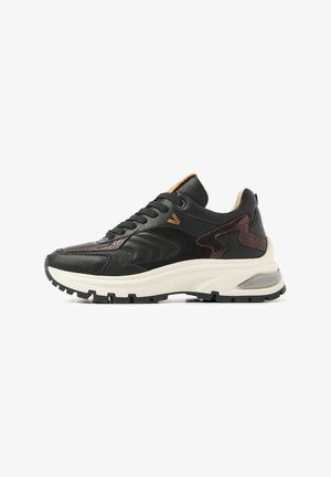 Black sneaker made of leather and suede, featuring a thick white sole, textured brown accents, and a padded collar. Robust tread.