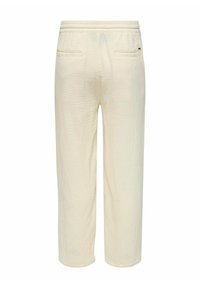 Pantalons blancs texturés à coupe ample, dotés d'une taille élastique et de deux poches arrière. Design simple et moderne.