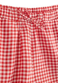 Rød og hvid ternet stof-pyjamasbukser med elastisk talje og snøre. Glat tekstur med løs pasform.