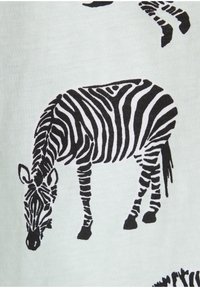 Schwarz-weiße Zebras-Illustration auf leicht pastellfarbener Stoffoberfläche, die eine grastende Pose mit markanten Streifen sowie Details von Mähne und Ohren zeigt.
