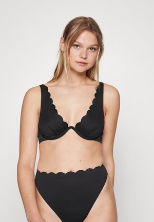 Black bikini set featuring textured fabric, scalloped trim on sleeves and waistband, and a plunging neckline design.