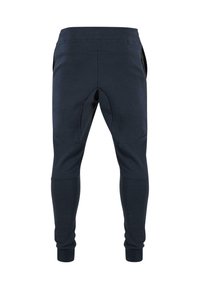 Námořnické tepláky s elastickým pasem, zúženými nohavicemi a bočními kapsami na zip. Hladká tkanina s kontrastními švy a tvarovaným designem kolen.