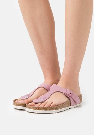 Pink rubber sandals with a toe loop and adjustable buckle, featuring a cork footbed and white rubber sole. Ideal for casual wear.