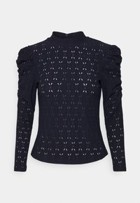 Tmavě modrý dlouhý rukáv s vysokým límcem, s nařasenými rukávy a celoplošným vzorem diamantových výřezů. Měkká textura, slim fit design.