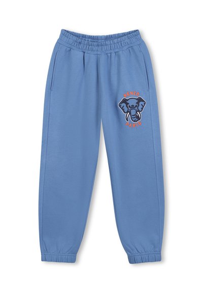 Jasnoniebieskie spodnie dresowe z miękkiego materiału, z grafiką słonia i napisem "KENZO PARIS" w pomarańczowym haftem. Elastyczny pas i mankiety.
