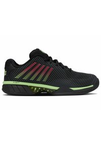 Baskets de sport noires avec accents verts, présentant un design supérieur rayé, une semelle texturée et un matériau léger et respirant.