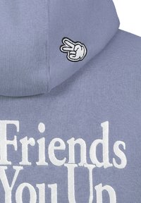 Light blue hoodie featuring white embroidered text "Friends" and "You Up." Small black and white peace sign graphic on the sleeve.