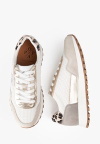 Zapatillas blancas con parte superior de malla, detalles en dorado y talón de estampado de leopardo. Materiales texturizados realzan el diseño. Suela de goma para tracción.