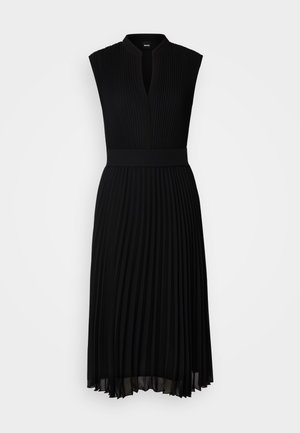 Black pleated dress with a v-neckline and sleeveless design. Features a fitted waistband and soft, flowy fabric. Elegant and simple silhouette.