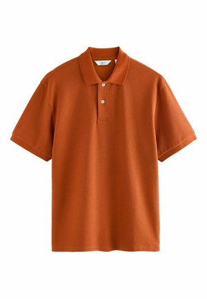 Rust-orange polo shirt with short sleeves, a collared neckline, three buttons, and a textured fabric. Clean and minimalist design.