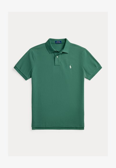 Green polo shirt made from cotton, featuring a classic collar, two buttons, short sleeves, and a small white logo on the left chest.