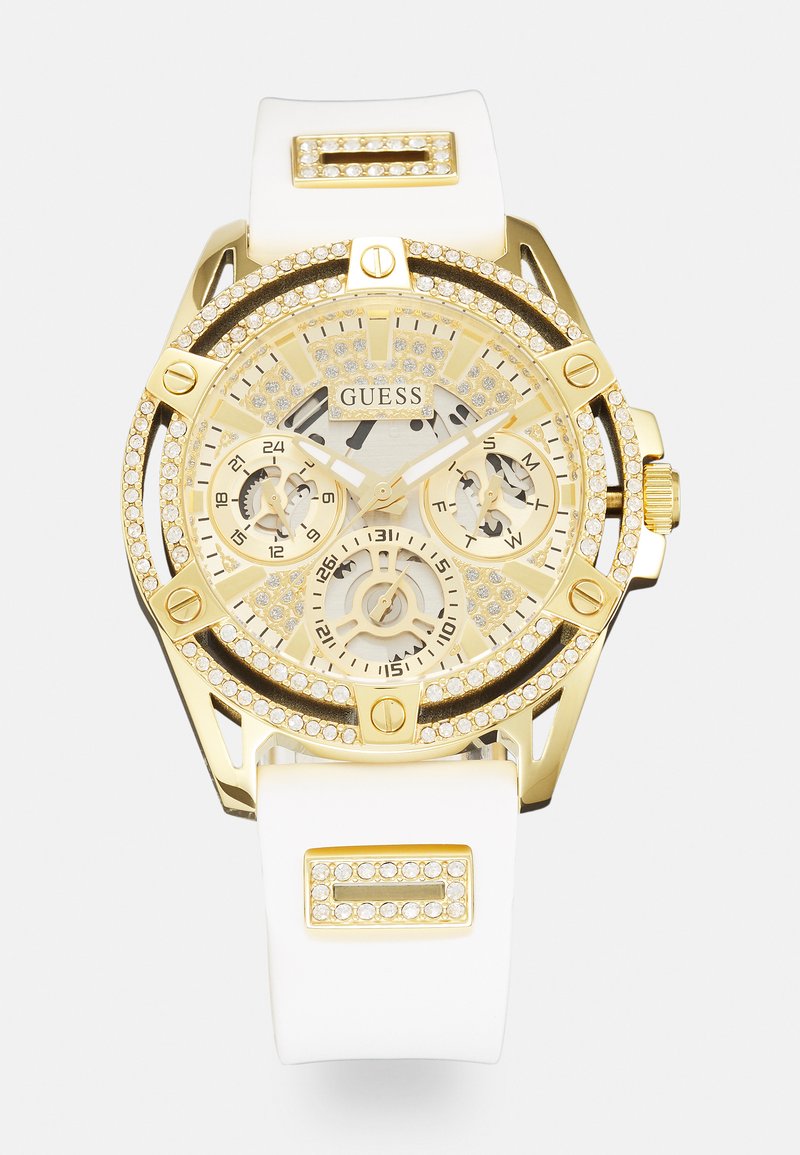 Goldfarbene Chronographuhr mit einem weißen Silikonarmband. Verfügt über ein strukturiertes Zifferblatt, Kristallverzierungen und mehrere Nebenziffernblätter für die Zeitmessung.