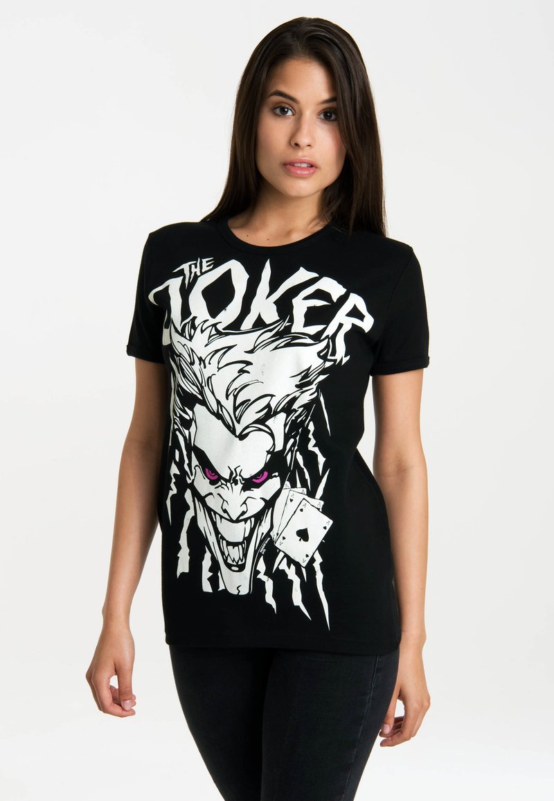 Black cotton t-shirt featuring a large graphic of the Joker with white and pink details, and an illustrated playing card.