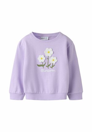 Lilla genser med lange ermer med tre hvite prestekrageblomster og grønne stilker, "Blossom"-tekst trykt under blomstene foran.