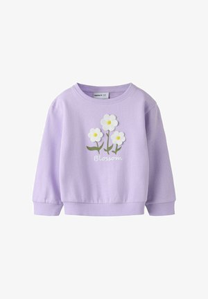 Lila dolg rokav zadrga s tremi belimi marjeticami in zelenimi stebli, spodaj na sprednji strani natisnjen napis "Blossom".