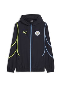 Giacca a vento blu navy con cappuccio, presenta accenti gialli e azzurri lungo i lati e un logo del Manchester City sul petto.