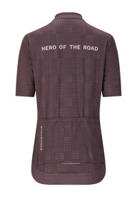 Maillot de cyclisme à manches courtes en mauve foncé avec des motifs à pois. Dispose du texte "HÉROS DE LA ROUTE" au dos et de trois poches arrière au niveau de l'ourlet.